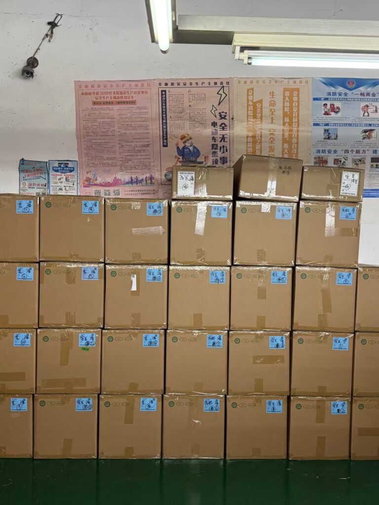 Stacks of boxed garment orders at Tetramade factory ready for international export and global shipping.