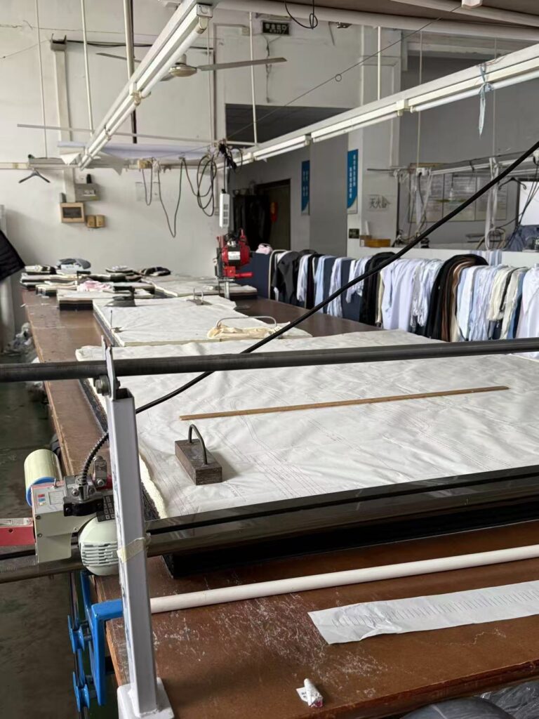 Professional garment cutting table and pattern making at Tetramade workshop in Shenzhen.